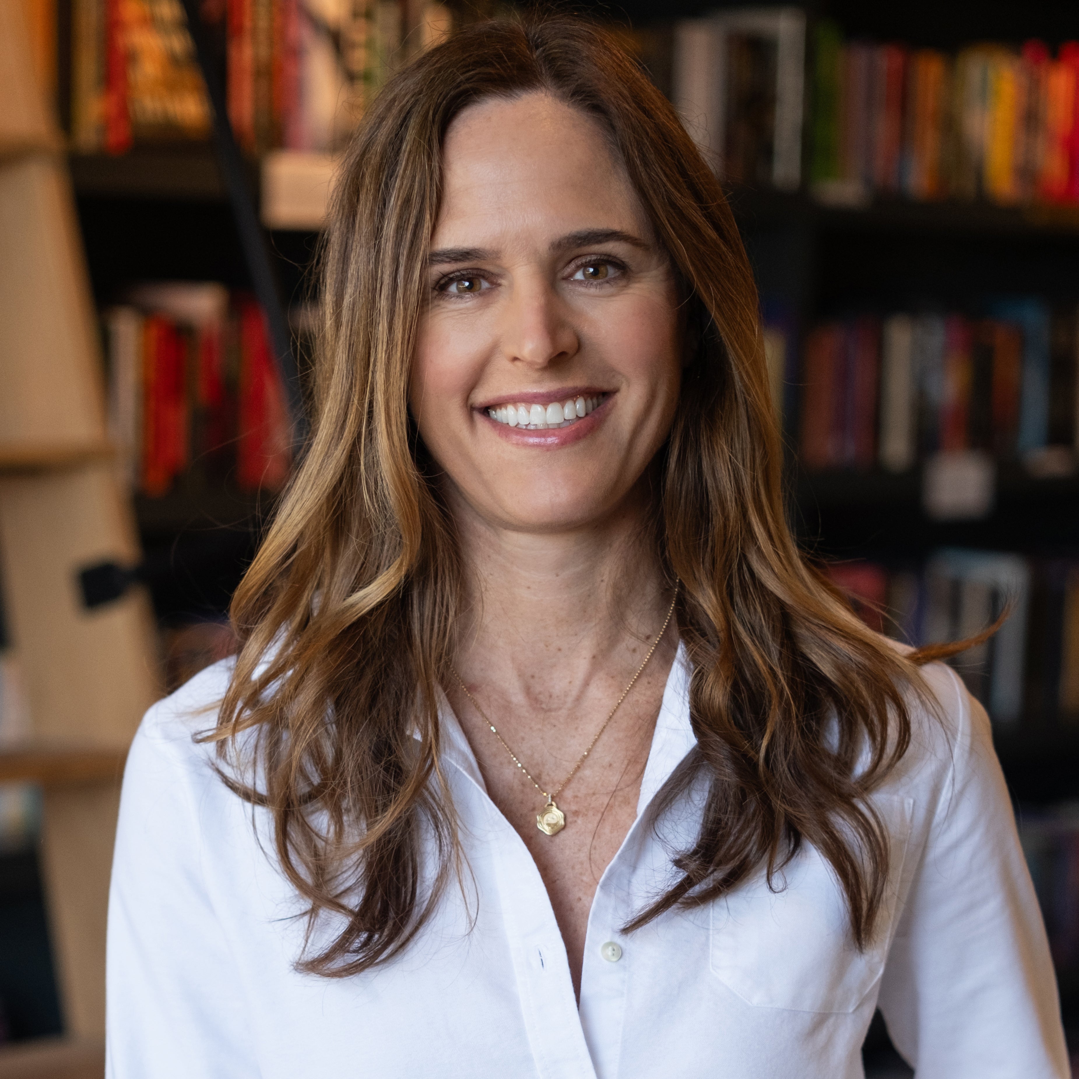 Sarah Murray in front of a wall of books.